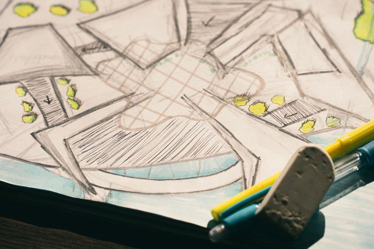Hand-drawn design sketch with pencils and markers